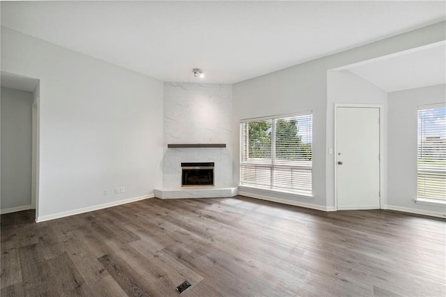 11224 Nieman Rd Unit 302, Overland Park, KS 66210 - unfurnished living room featuring plenty of natural light, a fireplace, wood finished floors, and lofted ceiling