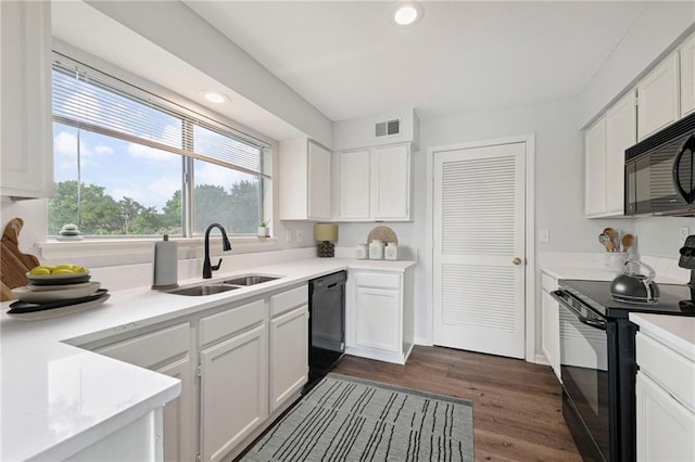 11224 Nieman Rd Unit 302, Overland Park, KS 66210 - kitchen featuring black appliances, white cabinetry, light countertops, recessed lighting, and dark wood-style flooring