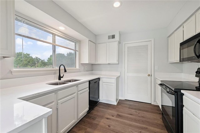 11224 Nieman Rd Unit 302, Overland Park, KS 66210 - kitchen with black appliances, white cabinetry, dark wood-style floors, light countertops, and recessed lighting