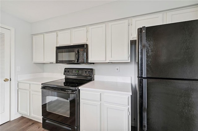 11224 Nieman Rd Unit 302, Overland Park, KS 66210 - kitchen featuring black appliances, light countertops, white cabinetry, and wood finished floors