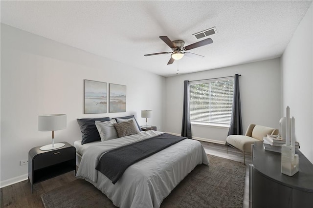 11224 Nieman Rd Unit 302, Overland Park, KS 66210 - bedroom featuring dark wood finished floors, ceiling fan, and a textured ceiling