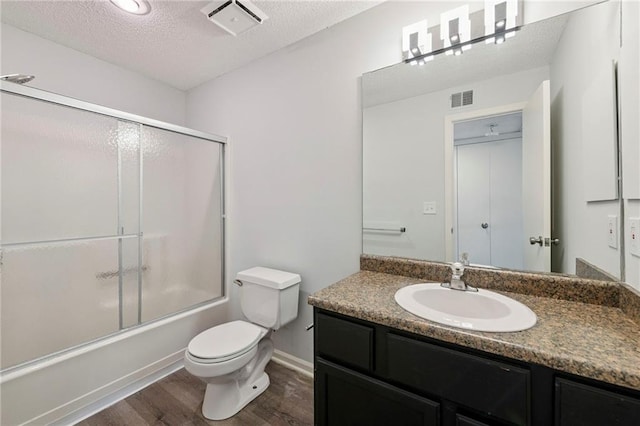 11224 Nieman Rd Unit 302, Overland Park, KS 66210 - full bath featuring wood finished floors, vanity, enclosed tub / shower combo, and a textured ceiling