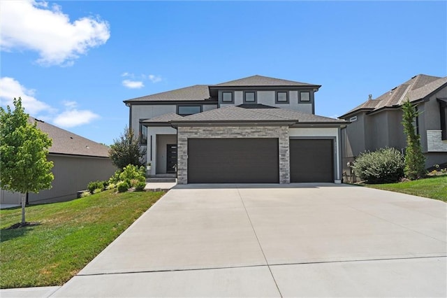 22615 W 87th Ter, Lenexa, KS 66227 - prairie-style home featuring a garage, a front lawn, driveway, and stucco siding