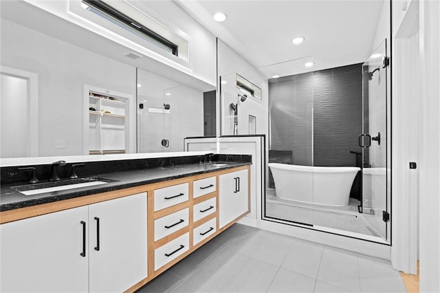 22615 W 87th Ter, Lenexa, KS 66227 - bathroom featuring double vanity, a freestanding bath, a shower stall, tile patterned floors, and recessed lighting