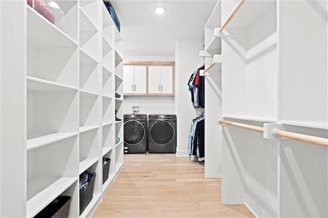 22615 W 87th Ter, Lenexa, KS 66227 - spacious closet with washing machine and clothes dryer and light wood finished floors