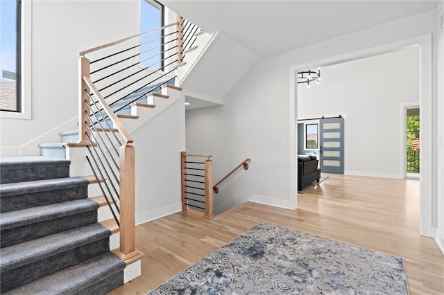22615 W 87th Ter, Lenexa, KS 66227 - stairs with wood finished floors and a barn door
