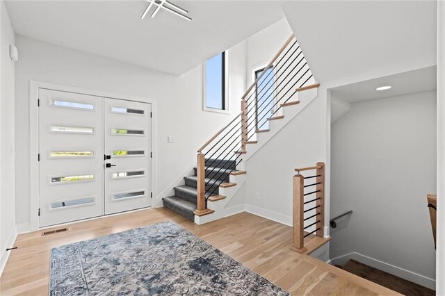 22615 W 87th Ter, Lenexa, KS 66227 - entryway with wood finished floors and stairway