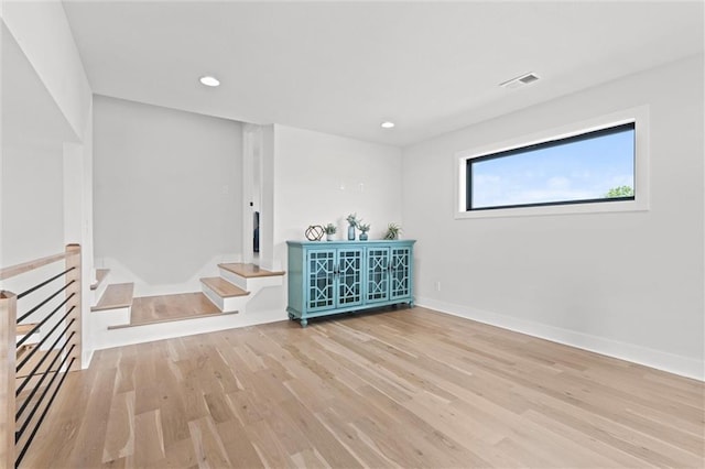 22615 W 87th Ter, Lenexa, KS 66227 - unfurnished room featuring light wood-style floors, recessed lighting, and stairway