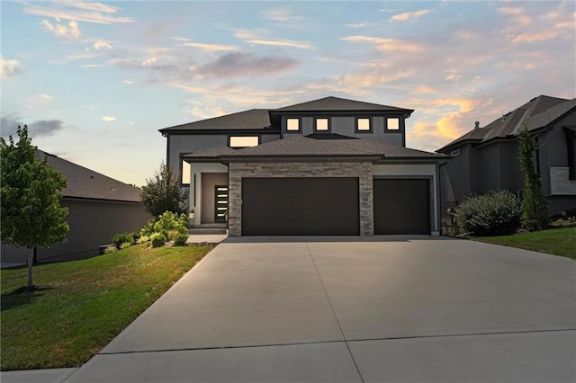 22615 W 87th Ter, Lenexa, KS 66227 - prairie-style home with a front lawn, an attached garage, concrete driveway, and stone siding