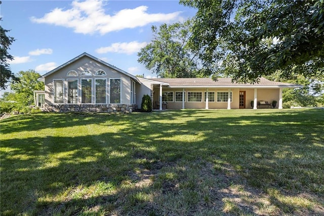 1015 S Wyckford Rd, Olathe, KS 66061 - rear view of property with a lawn and stucco siding
