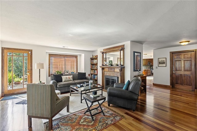 1015 S Wyckford Rd, Olathe, KS 66061 - living area featuring hardwood / wood-style floors, a fireplace, and a textured ceiling