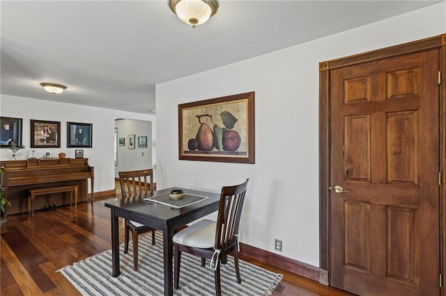 1015 S Wyckford Rd, Olathe, KS 66061 - dining area featuring dark wood finished floors and baseboards