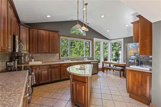1015 S Wyckford Rd, Olathe, KS 66061 - kitchen featuring appliances with stainless steel finishes, backsplash, light countertops, light tile patterned flooring, and a kitchen island