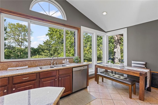 1015 S Wyckford Rd, Olathe, KS 66061 - kitchen featuring stainless steel dishwasher, lofted ceiling, light tile patterned floors, light countertops, and recessed lighting