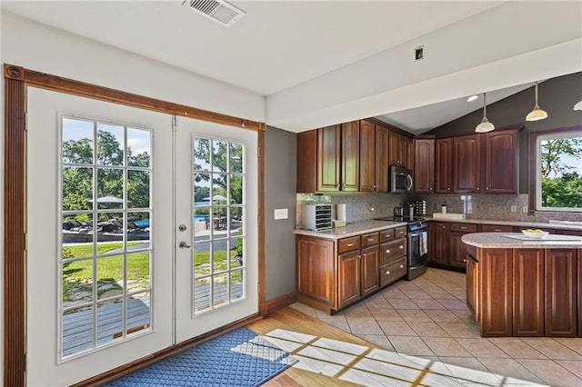 1015 S Wyckford Rd, Olathe, KS 66061 - kitchen with stainless steel appliances, backsplash, french doors, hanging light fixtures, and lofted ceiling
