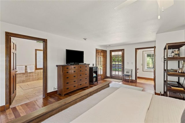 1015 S Wyckford Rd, Olathe, KS 66061 - bedroom featuring wood finished floors, access to outside, and ensuite bathroom
