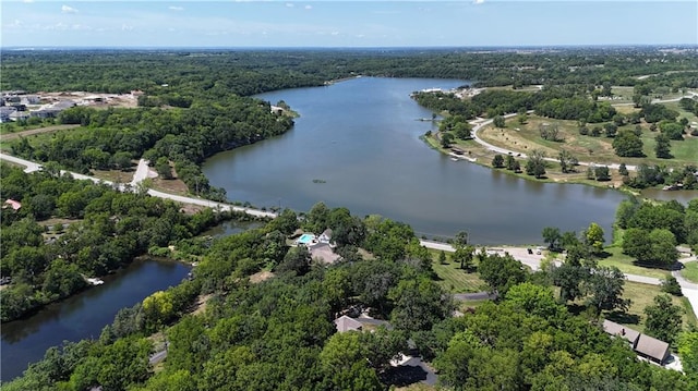 1015 S Wyckford Rd, Olathe, KS 66061 - drone / aerial view of a nearby body of water and a heavily wooded area
