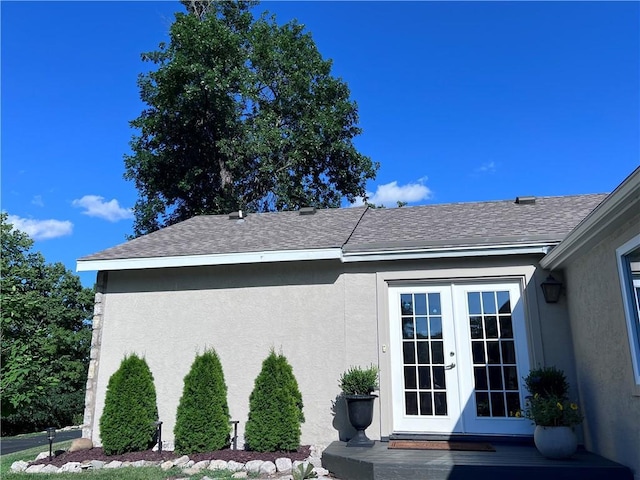 1015 S Wyckford Rd, Olathe, KS 66061 - view of property exterior featuring french doors, stucco siding, and a shingled roof