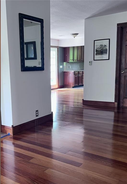 1015 S Wyckford Rd, Olathe, KS 66061 - unfurnished living room featuring dark wood-type flooring