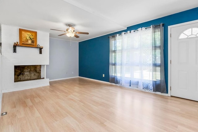 1202 S Willow St, Ottawa, KS 66067 - unfurnished living room with plenty of natural light, a ceiling fan, and wood finished floors