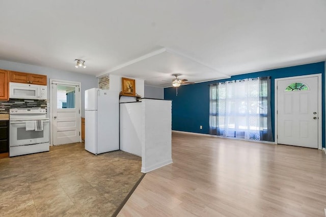 1202 S Willow St, Ottawa, KS 66067 - kitchen with white appliances, a ceiling fan, tasteful backsplash, light wood-style flooring, and brown cabinets