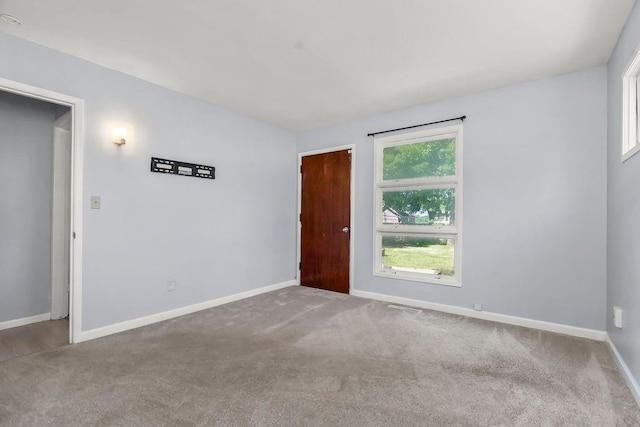 1202 S Willow St, Ottawa, KS 66067 - carpeted empty room with baseboards