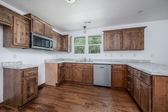 17931 Hollingsworth Rd, Tonganoxie, KS 66086 - kitchen with appliances with stainless steel finishes, dark wood-type flooring, light countertops, and a peninsula