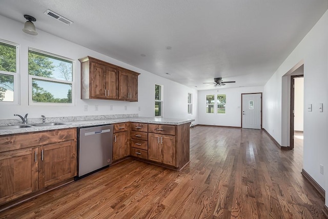17931 Hollingsworth Rd, Tonganoxie, KS 66086 - kitchen featuring dishwasher, a peninsula, dark wood-style flooring, open floor plan, and light countertops