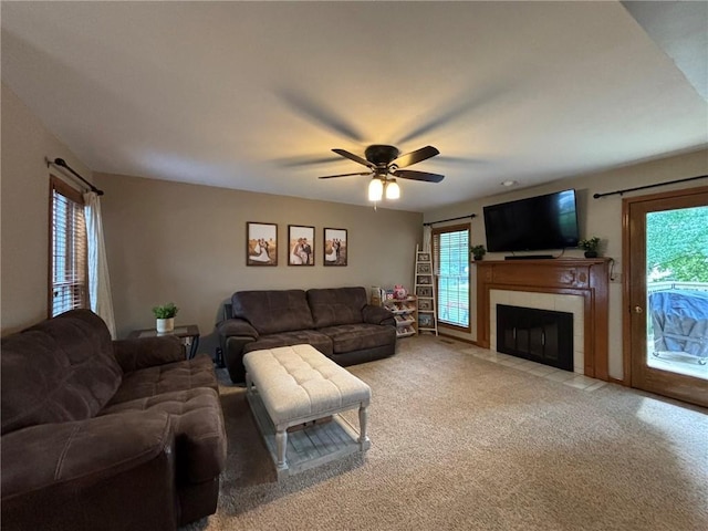 2006 Buckingham St, Saint Joseph, MO 64506 - living area with light carpet, a tile fireplace, and a ceiling fan