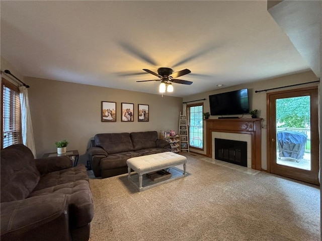 2006 Buckingham St, Saint Joseph, MO 64506 - living room featuring ceiling fan, light colored carpet, and a tile fireplace