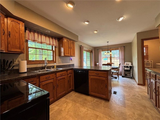 2006 Buckingham St, Saint Joseph, MO 64506 - kitchen featuring black appliances, a peninsula, brown cabinets, dark countertops, and recessed lighting