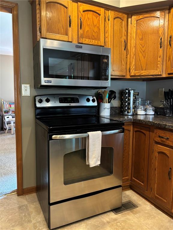 2006 Buckingham St, Saint Joseph, MO 64506 - kitchen featuring stainless steel appliances and brown cabinetry
