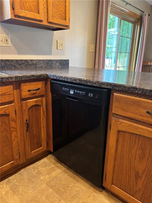 2006 Buckingham St, Saint Joseph, MO 64506 - kitchen featuring black dishwasher, brown cabinets, and dark countertops