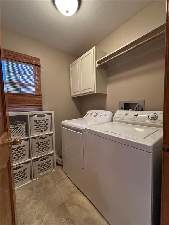 2006 Buckingham St, Saint Joseph, MO 64506 - laundry room featuring cabinet space, independent washer and dryer, and light stone finish floors