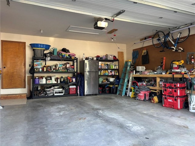 2006 Buckingham St, Saint Joseph, MO 64506 - garage featuring freestanding refrigerator and a garage door opener