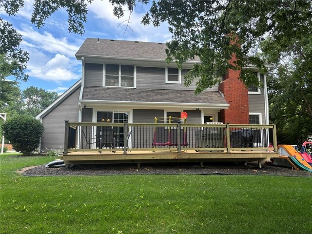2006 Buckingham St, Saint Joseph, MO 64506 - rear view of property featuring a lawn, a deck, and roof with shingles