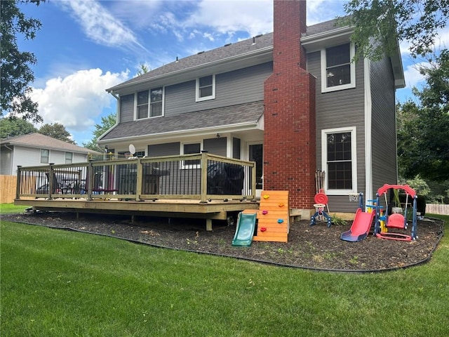 2006 Buckingham St, Saint Joseph, MO 64506 - back of property with a chimney, a yard, a wooden deck, and a playground