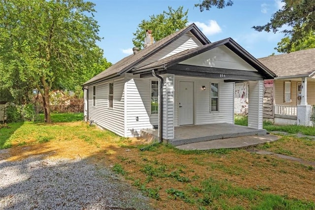 804 S Cedar Ave, Independence, MO 64053 - shotgun-style home featuring a porch, a chimney, and roof with shingles