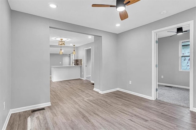 804 S Cedar Ave, Independence, MO 64053 - unfurnished living room with ceiling fan, wood finished floors, and recessed lighting