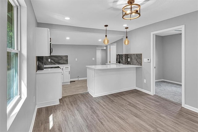 804 S Cedar Ave, Independence, MO 64053 - kitchen with wood finished floors, healthy amount of natural light, white cabinets, decorative backsplash, and recessed lighting