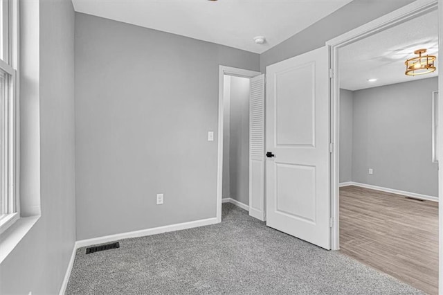 804 S Cedar Ave, Independence, MO 64053 - unfurnished bedroom featuring baseboards and carpet floors
