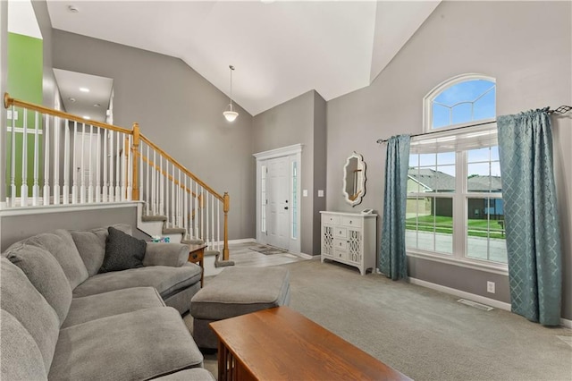 2105 NW Sweetgum Ct, Grain Valley, MO 64029 - carpeted living area with high vaulted ceiling and stairway