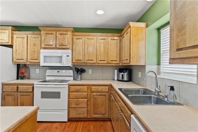 2105 NW Sweetgum Ct, Grain Valley, MO 64029 - kitchen with white appliances, light countertops, tasteful backsplash, and light wood-type flooring