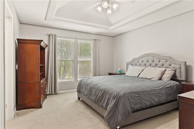2105 NW Sweetgum Ct, Grain Valley, MO 64029 - bedroom featuring a tray ceiling, light colored carpet, and ceiling fan