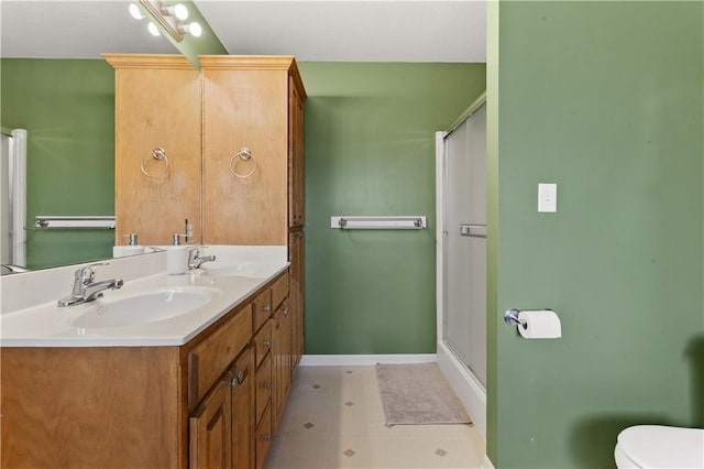 2105 NW Sweetgum Ct, Grain Valley, MO 64029 - bathroom with double vanity, a shower stall, and tile patterned floors