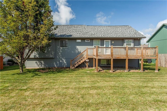 2105 NW Sweetgum Ct, Grain Valley, MO 64029 - back of property featuring a wooden deck, a yard, stairs, and a shingled roof