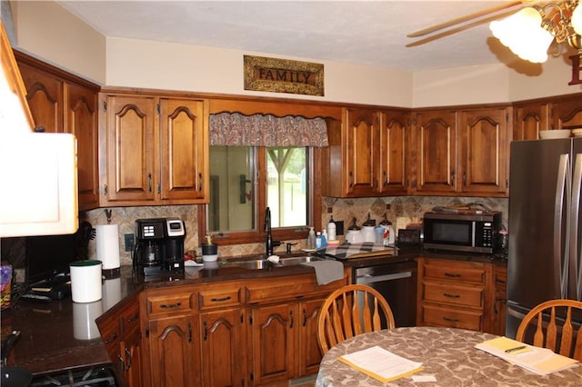 612 N 4th St, Arma, KS 66712 - kitchen featuring stainless steel appliances, brown cabinetry, backsplash, and dark countertops