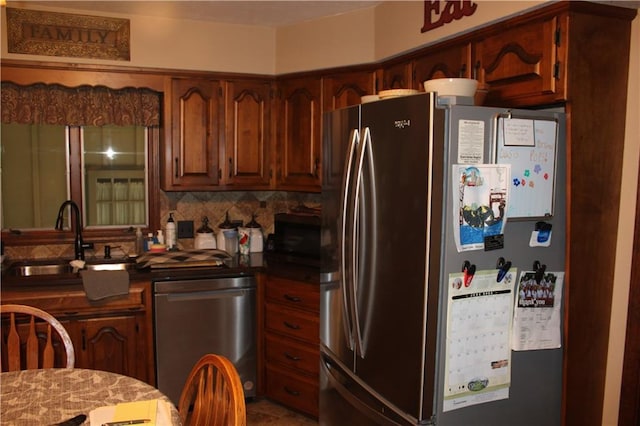 612 N 4th St, Arma, KS 66712 - kitchen featuring appliances with stainless steel finishes, decorative backsplash, and dark countertops
