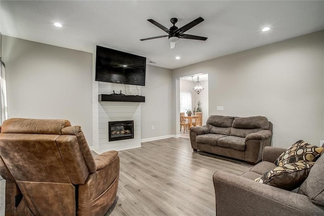 311 S 3rd St, Odessa, MO 64076 - living area featuring light wood-style floors, recessed lighting, ceiling fan, and a fireplace