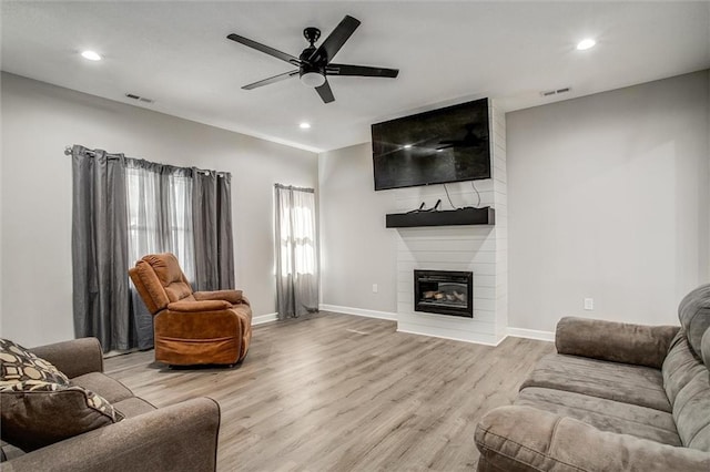 311 S 3rd St, Odessa, MO 64076 - living area with a fireplace, light wood-style flooring, recessed lighting, and ceiling fan